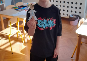 Chłopiec prezentuje własnoręcznie wykonaną kukiełkę.